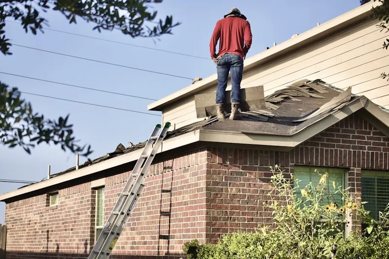 Professional roofer working on a residential roof in Coopers Pond